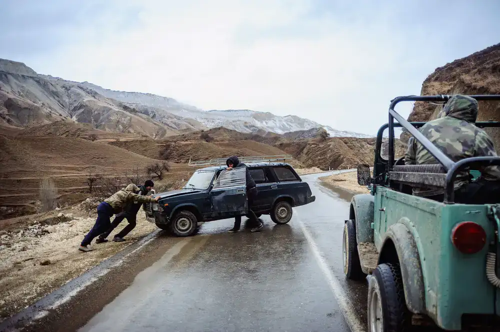 Tyre fitter helping a stranded driver on the roadside