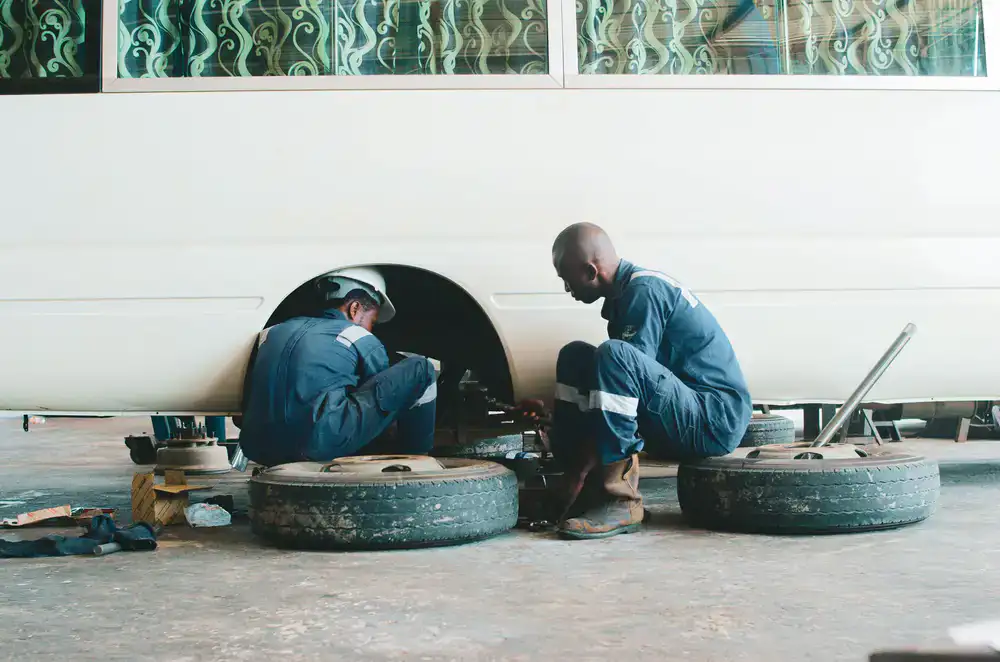 Professional mechanic replacing a vehicle tyre on-site